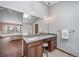 Bright bathroom featuring a double vanity, granite countertop, modern fixtures, and an open layout leading to the bedroom at 18263 E Berry Dr, Centennial, CO 80015