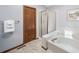 Bathroom features a separate shower, soaking tub, tile floor, and bright light at 18263 E Berry Dr, Centennial, CO 80015