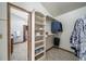 Walk-in closet features ample shelving, custom organizers, and easy access to the bedroom and bathroom at 18263 E Berry Dr, Centennial, CO 80015