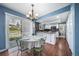 Charming dining area featuring a sliding glass door to the backyard, chandelier, and updated kitchen at 18263 E Berry Dr, Centennial, CO 80015