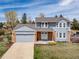 Charming two-story home featuring a well-manicured lawn, brick accents, and an attached two-car garage at 18263 E Berry Dr, Centennial, CO 80015