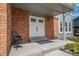 Inviting entryway with double doors, brick accents, and a concrete porch for curb appeal at 18263 E Berry Dr, Centennial, CO 80015