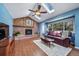 Cozy living room with a brick fireplace, wood floors, skylights and comfortable seating at 18263 E Berry Dr, Centennial, CO 80015