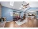 Bright living room with a brick fireplace and wood floors, open to the kitchen and dining area at 18263 E Berry Dr, Centennial, CO 80015