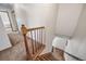 Carpeted staircase with wood railing and balusters leading to the lower level at 18263 E Berry Dr, Centennial, CO 80015