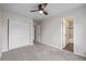 Neutral bedroom featuring a ceiling fan, a closet, and a bathroom, offering a comfortable and functional living space at 116 S Lindsey St, Castle Rock, CO 80104