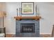 Close-up of a modern gas fireplace with stone surround and a wooden mantel at 116 S Lindsey St, Castle Rock, CO 80104
