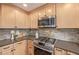 Close-up of the kitchen featuring stainless steel appliances and wooden cabinets at 116 S Lindsey St, Castle Rock, CO 80104