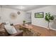 Cozy living room with a leather sofa, decorative wall art, wood floors, and a flat-screen TV at 116 S Lindsey St, Castle Rock, CO 80104