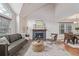 Bright living room with a cozy fireplace, comfortable seating, and wood flooring at 116 S Lindsey St, Castle Rock, CO 80104