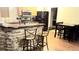 Open kitchen area with granite counters, stone accents, and a connected breakfast nook at 785 Century Ln, Monument, CO 80132