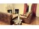 Cozy living room with hardwood floors, a stone fireplace, and comfortable leather seating at 785 Century Ln, Monument, CO 80132