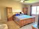 Spacious main bedroom featuring matching wood dressers and neutral walls with a ceiling fan and a large window at 785 Century Ln, Monument, CO 80132