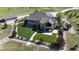 Aerial view of a meticulously landscaped home featuring lush lawns, mature trees, and a winding driveway at 960 Promontory Cir, Elizabeth, CO 80107