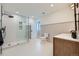 Bright bathroom features a walk-in glass shower, modern fixtures, and wainscoting at 960 Promontory Cir, Elizabeth, CO 80107