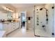 Bright bathroom showcasing double vanity with marble countertop and large glass shower with bench at 960 Promontory Cir, Elizabeth, CO 80107