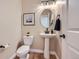 Chic powder room featuring a pedestal sink, modern fixtures, and neutral color palette at 960 Promontory Cir, Elizabeth, CO 80107