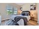 Cozy bedroom with modern decor, stylish rug, and sun-filled views through two large windows at 960 Promontory Cir, Elizabeth, CO 80107
