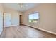 Well-lit bedroom featuring hardwood floors, a ceiling fan, and scenic views through the large window at 960 Promontory Cir, Elizabeth, CO 80107