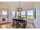 Bright dining area with expansive windows offering scenic views and stylish modern furnishings at 960 Promontory Cir, Elizabeth, CO 80107