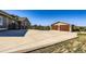 Spacious driveway leading to a detached garage and a beautiful home, with scenic views of the surrounding landscape at 960 Promontory Cir, Elizabeth, CO 80107