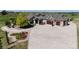 Sprawling home featuring a circular driveway, and a well-manicured lawn with mature trees and landscaping at 960 Promontory Cir, Elizabeth, CO 80107