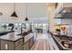 Bright kitchen features a large island, modern appliances, and an open layout flowing to the dining area at 960 Promontory Cir, Elizabeth, CO 80107
