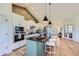 Bright kitchen with stainless steel appliances, center island, and stylish pendant lighting at 960 Promontory Cir, Elizabeth, CO 80107