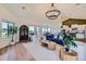 Open-concept living room with bright light, hardwood floors, and seamlessly connected to the kitchen and dining area at 960 Promontory Cir, Elizabeth, CO 80107