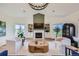 Bright living room featuring a fireplace, built-in shelving, and lots of natural light at 960 Promontory Cir, Elizabeth, CO 80107
