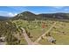 Aerial view of property and neighborhood in a wooded area with mountain views at 11173 Emerald Ln, Conifer, CO 80433