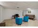 Finished basement with tile flooring, bright lights, television set, and comfortable seating at 11173 Emerald Ln, Conifer, CO 80433
