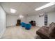 Finished basement with tile flooring, fireplace, bright lights, and comfortable seating at 11173 Emerald Ln, Conifer, CO 80433