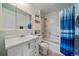 Functional bathroom featuring a tub, shower with curtain, built-in shelves and a large mirror at 11173 Emerald Ln, Conifer, CO 80433
