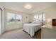 Bright bedroom featuring natural light, carpeted floors and white walls with sheer curtains at 11173 Emerald Ln, Conifer, CO 80433