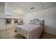 This finished basement bedroom has a queen-sized bed, decorative chair and tiled floor at 11173 Emerald Ln, Conifer, CO 80433