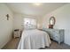 Comfortable bedroom with carpeted floors, soft lighting, neutral color palette and two windows at 11173 Emerald Ln, Conifer, CO 80433
