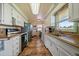 Well-lit kitchen featuring tiled floors, white cabinets, and view of a bright window at 11173 Emerald Ln, Conifer, CO 80433