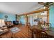 Comfortable living and dining area featuring a wood-burning stove, wood floors, and an open floor plan at 11173 Emerald Ln, Conifer, CO 80433