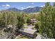Scenic aerial view of the home, surrounded by lush trees and with stunning mountain views in the background at 270 31St St, Boulder, CO 80305