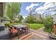 Relaxing outdoor dining area on a wooden deck with a table, chairs, and a view of the lush backyard at 270 31St St, Boulder, CO 80305