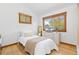 Bright bedroom with hardwood floors and two windows overlooking a green landscape at 270 31St St, Boulder, CO 80305