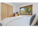Bedroom featuring hardwood floors, a dresser, and natural light from a large window at 270 31St St, Boulder, CO 80305