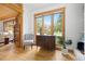 Entryway featuring hardwood floors, cabinet, stylish furniture, and view to large window with mountain views at 270 31St St, Boulder, CO 80305