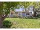 Charming single-story home with well-kept lawn, mature trees, and blooming flowerbeds at 270 31St St, Boulder, CO 80305