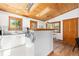 Bright kitchen boasts white cabinets, modern countertops, and stylish wood-trimmed windows and ceiling skylights at 270 31St St, Boulder, CO 80305