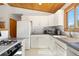 Well-lit kitchen featuring white cabinetry, stainless steel appliances, and ample counter space at 270 31St St, Boulder, CO 80305