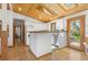 Open kitchen showcasing wood ceilings, white cabinets, and access to an outdoor dining area at 270 31St St, Boulder, CO 80305