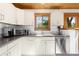Bright kitchen with white cabinets, modern appliances, and a view to the backyard at 270 31St St, Boulder, CO 80305