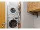 Laundry area features modern stacked washer and dryer with organized shelving at 270 31St St, Boulder, CO 80305